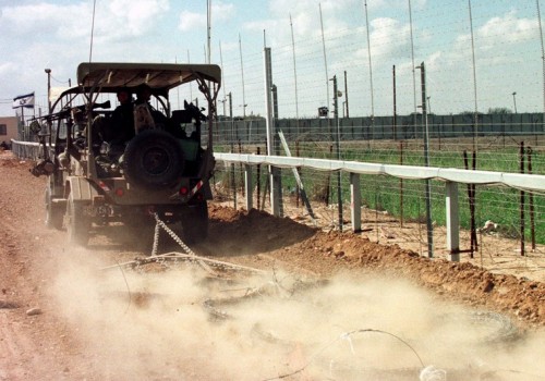 A Israeli army #safari# truck kicks up dust as it patrols March 19 along the electronic fence separating the Gaza Strip from Israel as it drags a sled of barbed wire to smooth the dirt. Israel always maintains tight security along their borders including frequent patrols. Following the wave of bus attacks inside Israel which killed almost 60 people Israel sealed the Gaza Strip and until today has not allowed workers to cross into Israel for work. Some produce is allowed by Israel to both enter the Gaza Strip and be exported from Gaza. ISRAEL - RTRB4B