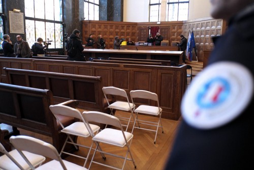 A guard stands by as the files for the trial regarding the PIP (Poly Implant Prostheses) case are presented to the press on December 9, 2013 in a courtroom in Marseille. After a trial lasting months last spring, the Correctional Court of Marseille is expected on December 10 to make a ruling regarding the case of defective PIP breast implants and the responsibility of PIP managers, including founder Jean-Claude Mas.  AFP PHOTO / BORIS HORVAT