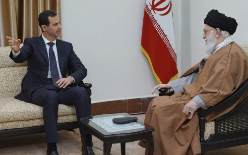 In this photo released by the Syrian official news agency SANA, Syrian President Bashar Assad, left, speaks with Iranian Supreme Leader Ayatollah Ali Khamenei, before their meeting in Tehran, Syria, Monday, Feb. 25, 2019. SANA said Assad met with Supreme Leader Ayatollah Ali Khamenei and President Hassan Rouhani on the trip, the first time he has traveled anywhere other than Russia since the Syrian civil war erupted nearly eight years ago. (SANA via AP)