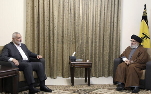 This picture released by the Hezbollah Media Relations Office, shows Hezbollah leader Sayyed Hassan Nasrallah, right, meeting with Ismail Haniyeh, the leader of the Palestinian militant group Hamas, in Beirut, Lebanon, Tuesday, June 29, 2021. (Hezbollah Media Relations Office, via AP )