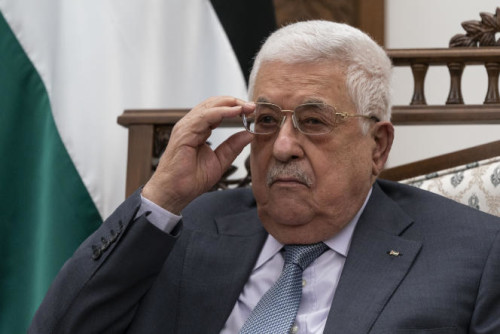 FILE - Palestinian President Mahmoud Abbas adjusts his glasses as he listens during a joint statement with Secretary of State Antony Blinken, Tuesday, May 25, 2021, in West Bank city of Ramallah. Abbas met with Israeli Defense Minister Benny Gantz at Gantz's private residence in a Tel Aviv suburb late Tuesday, Dec. 28, 2021. The two discussed security coordination between Israel and Abbas' Palestinian Authority, which administers pockets of the occupied West Bank. (AP Photo/Alex Brandon, Pool, File)