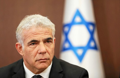 (FILES) In this file photo taken on May 15, 2022, Israeli Foreign Minister Yair Lapid attends a cabinet meeting at the Prime minister's office in Jerusalem. The leaders of Israel's governing coalition said on June 20 that they will submit a bill next week to dissolve parliament, legislation that would force new elections if approved. (Photo by Abir SULTAN / POOL / AFP)