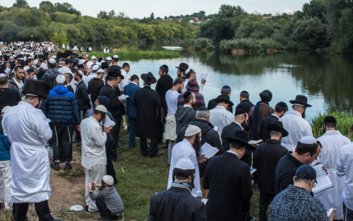 UMAN, UKRAINE - SEPTEMBER 14: Hasidic pilgrims pray along a river, not far from the burial site of Rebbe Nachman of Breslov on September 14, 2015 in Uman, Ukraine. Every year, tens of thousands of Hasidim gather for Rosh Hashanah in the city to pray at the holy site. (Photo by Brendan Hoffman/Getty Images)