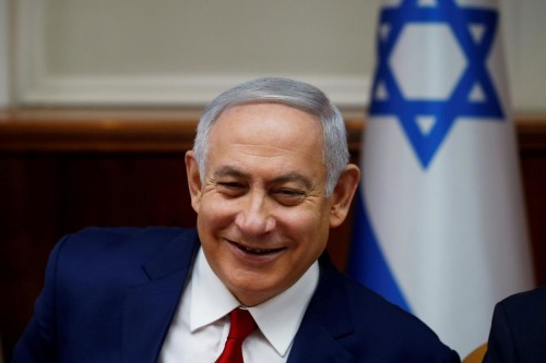 FILE PHOTO: Israeli Prime Minister Benjamin Netanyahu smiles during the weekly cabinet meeting in Jerusalem December 23, 2018. REUTERS/Ronen Zvulun/File Photo