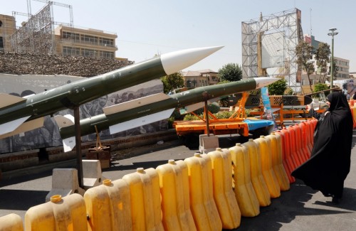 An Iranian woman looks at Taer-2 missile during a street exhibition by Iran's army and paramilitary Revolutionary Guard celebrating " Defence Week" marking the 39th anniversary of the start of 1980-88 Iran-Iraq war, at the Baharestan Square in Tehran, on September 26, 2019. (Photo by STRINGER / AFP)