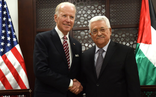 US Vice President Joe Biden, left, and Palestinian President Mahmoud Abbas, shake hands for the press at the presidential compound in Ramallah, West Bank, Wednesday, March 9, 2016. (Debbie Hill, Pool via AP)