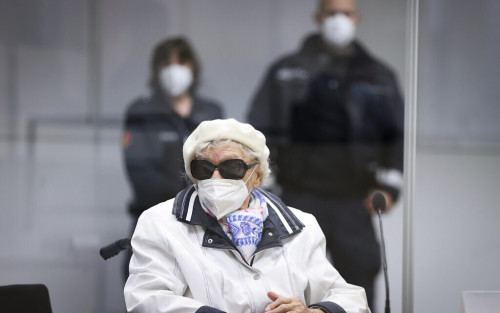 The 96-year-old defendant Irmgard F. sits in the courtroom at the beginning of the trial day in Itzehoe, Germany, Tuesday, Nov. 9, 2021. The trial against the former concentration camp secretary at the Itzehoe Regional Court continues. The 96-year-old is charged with accessory to murder in over 11,000 cases in the Stutthof concentration camp. (Christian Charisius/Pool via AP)