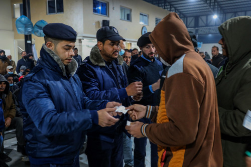 Palestinian workers wait at the Erez crossing in Beit Hanun, in the northern Gaza Strip, as they wait to enter Israel for work, on March 13, 2022. Photo by Attia Muhammed/Flash90  *** Local Caption *** מעבר ארז מחכים עומדים תור כניסה ישראל פלסטינאים צד פועלים עבודה