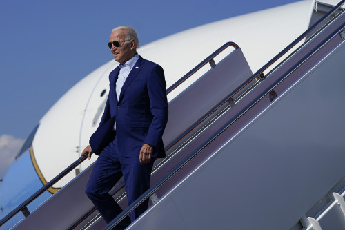 President Joe Biden exits Air Force One, Wednesday, July 20, 2022, at Andrews Air Force Base, Md. Biden is returning from a trip to Somerset, Mass., where he spoke about climate change. (AP Photo/Evan Vucci)