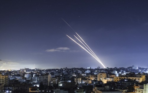 Rockets are launched towards Israel from Gaza City, controlled by the Palestinian Hamas movement, on May 18, 2021. - Heavy air strikes and rocket fire in the Israel-Gaza conflict claimed more lives on both sides as tensions flared in Palestinian "day of anger" protests in Jerusalem and the West Bank. Calls for a ceasefire intensified, but Prime Minister Benjamin Netanyahu vowed Israel would continue its onslaught on the coastal enclave "as long as necessary," before a UN Security Council meeting broke up after less than an hour without issuing a statement. (Photo by MAHMUD HAMS / AFP)