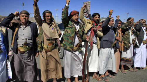 Yemeni tribesmen chant attend a rally denouncing the United States and the outgoing Trump administration's decision to apply the "terrorist" designation to the Iran-backed movement, in the Huthi-held capital Sanaa on February 4, 2021.