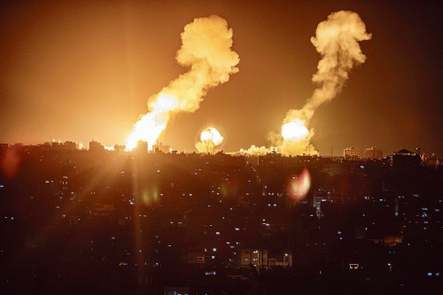 This picture taken early on April 7, 2023 shows explosions in Khan Yunis in the southern Gaza Strip during Israeli air strikes on the Palestinian enclave. (Photo by AFP)