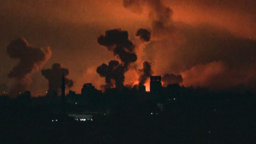 This image grab from an AFP TV footage shows fire and smoke rising above Gaza City during an Israeli strike on October 27, 2023, as battles between Israel and the Palestinian Hamas movement continue. The Israeli army on the evening of October 27 carried out bombings of "unprecedented" intensity since the start of the war in the north of the Gaza Strip, particularly in Gaza City, according to images from AFP and the Hamas movement. (Photo by AFP)