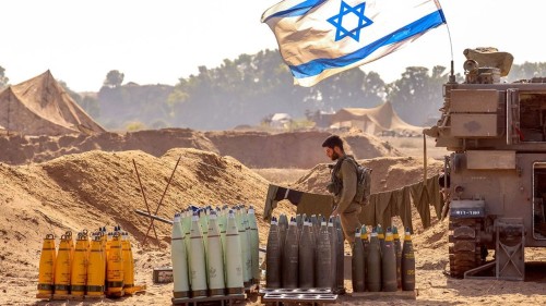 An Israeli soldier arranges artillery shells at a position near the border with the Gaza Strip in southern Israel on November 6, 2023 amid the ongoing battles between Israel and the Palestinian group Hamas in the Gaza Strip. (Photo by JACK GUEZ / AFP)