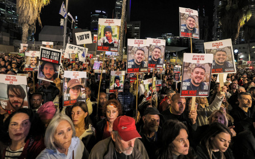 Protesters gather with signs showing portraits of Israeli hostages held in Gaza since the October 7 attacks during a demonstration calling for their release outside the Tel Aviv Museum of Art, now informally called the "Hostages Square", in Tel Aviv on December 9, 2023. - Israeli forces have encircled major urban centres in the Gaza Strip as they seek to destroy Hamas over its unprecedented attack in October when militants broke through Gaza's militarised border to kill around 1,200 people and seize hostages, 138 of whom remain captive according to Israeli figures. (Photo by AHMAD GHARABLI / AFP)