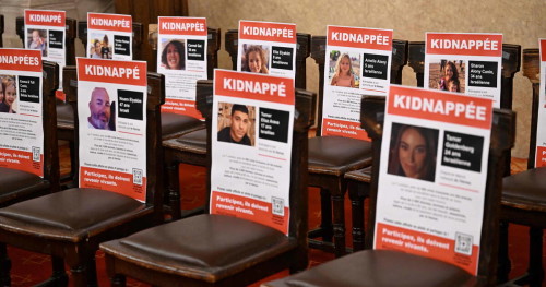 Portraits of hostages abducted by Palestinian militants during the October 7 attack and currently held in the Gaza Strip are seen on chairs during an event held under the theme of "unity" and calling for their release, at the Great Synagogue of Paris, known as Synagogue de la Victoire, in Paris, on October 31, 2023. (Photo by Miguel MEDINA / AFP)