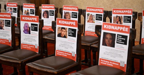 Portraits of hostages abducted by Palestinian militants during the October 7 attack and currently held in the Gaza Strip are seen on chairs during an event held under the theme of "unity" and calling for their release, at the Great Synagogue of Paris, known as Synagogue de la Victoire, in Paris, on October 31, 2023. (Photo by Miguel MEDINA / AFP)