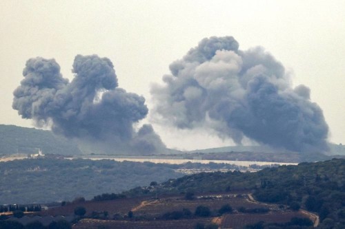 TOPSHOT - This picture taken from a position along the border in northern Israel on December 27, 2023 shows smoke billowing in the southern Lebanese village of Marwahin following Israeli bombardment amid ongoing cross-border tensions as fighting continues between Israel and Hamas militants in the Gaza Strip. (Photo by jalaa marey / AFP)