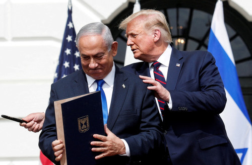 FILE PHOTO: Israeli Prime Minister Benjamin Netanyahu stands with U.S. President Donald Trump after signing the Abraham Accords, normalizing relations between Israel and some of its Middle East neighbors, in a strategic realignment of Middle Eastern countries against Iran, on the South Lawn of the White House in Washington, U.S., September 15, 2020. REUTERS/Tom Brenner/File Photo
