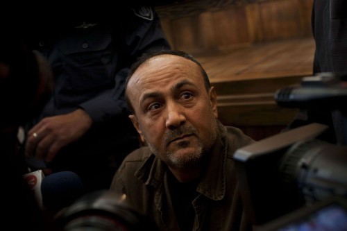 FILE - In this file photo taken Wednesday, Jan. 25, 2012, senior Fatah leader Marwan Barghouti appears at Jerusalem's court. According to several top officials, the Palestinians are seeking the freedom of Barghouti, who is serving multiple life sentences for his alleged role in killings of Israelis, as part of any plan to extend negotiations with Israel beyond a deadline in April, 2014. (AP Photo/Bernat Armangue, File)/CAI107/949275677849/FILE PHOTO TAKEN WEDNESDAY, JAN. 25, 2012/1403191958